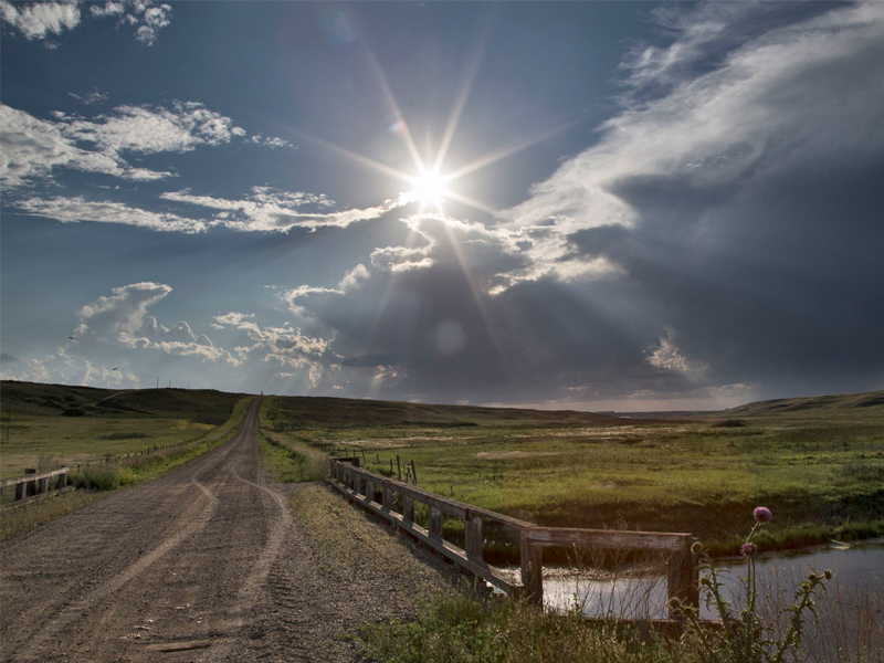 Saskatchewan field with old bridge