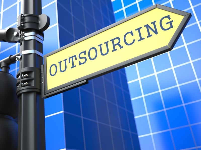outsourcing word on yellow roadsign on blue urban background