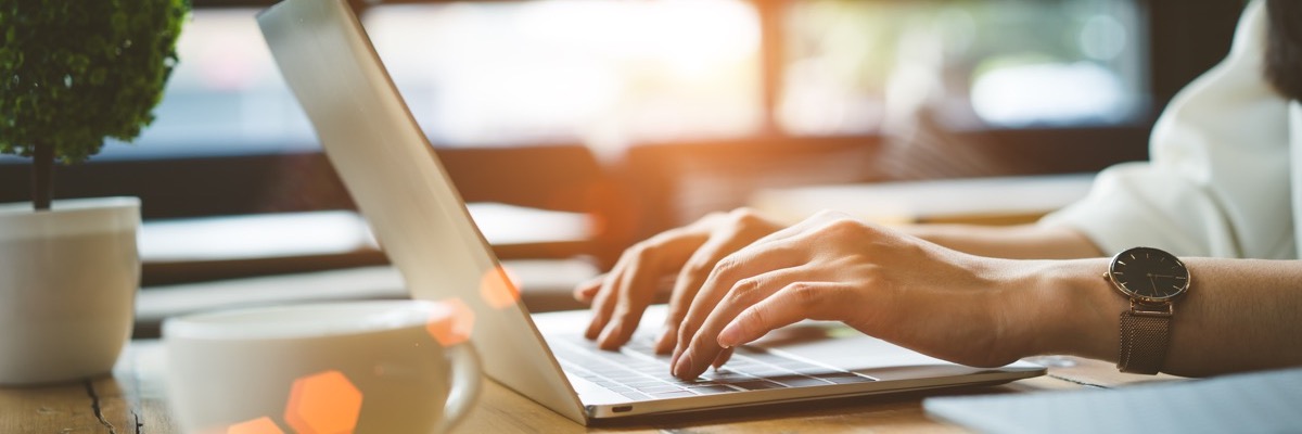 person on laptop with coffee