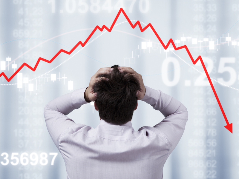 Businessman standing in front of the panel with financial statistics
