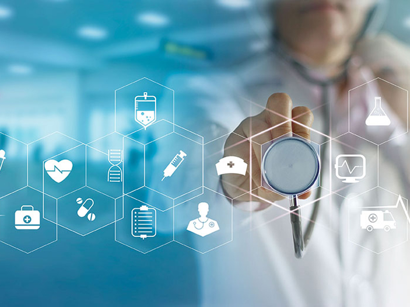 A doctor holding a stethoscope in front of healthcare icons