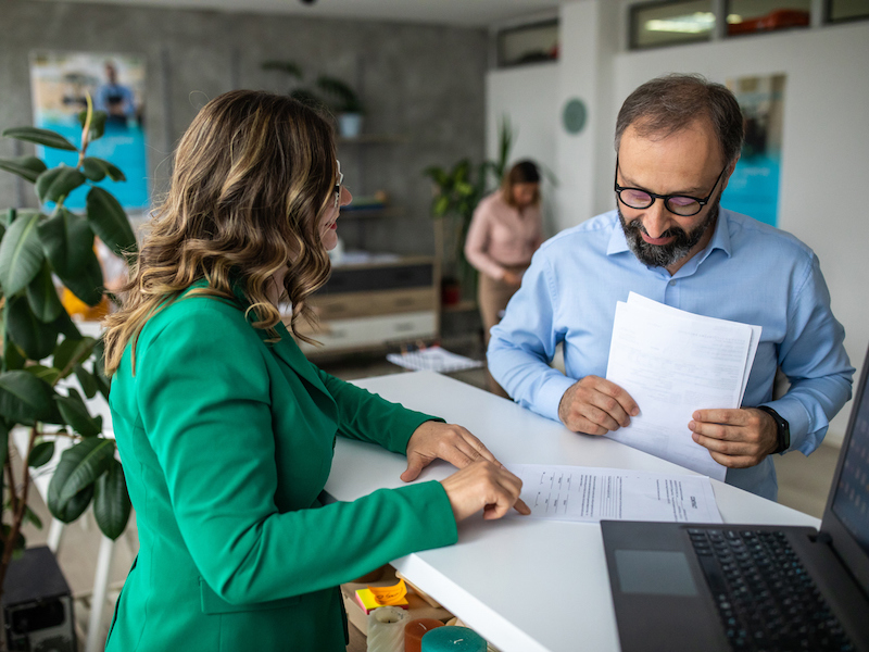 Businessman talking with financial advisor in bank