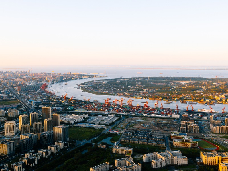 Aerial view of Shanghai skyline. Top view of deep water port with cargo ship and containers in Shanghai.