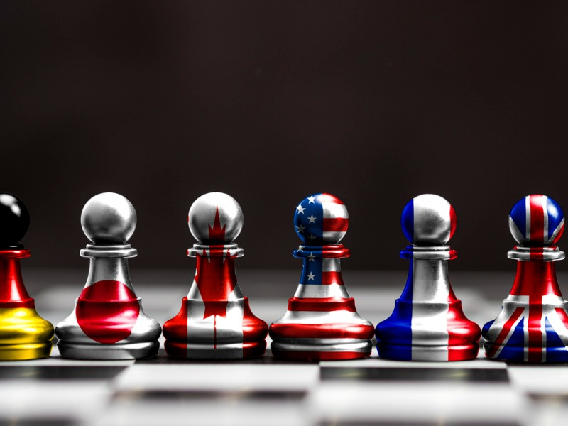 Flag of G7 countries print screen on pawn chess with black background. G7 are includes USA Germany Japan Canada France England and Italy.