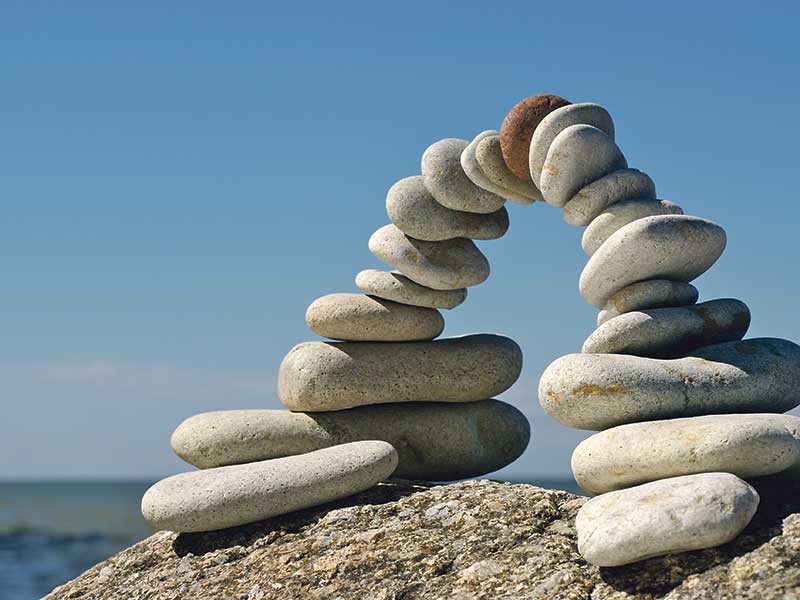 Arch formed with river rocks on beach