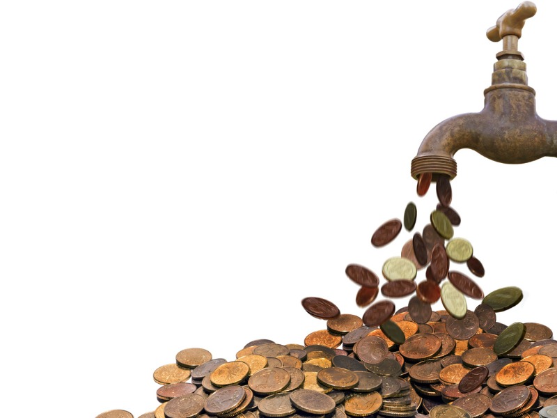 Coin pouring faucet stock photo