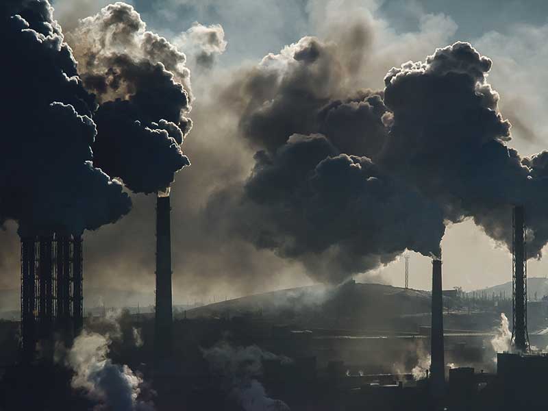 Smoke stacks spewing dark smoke