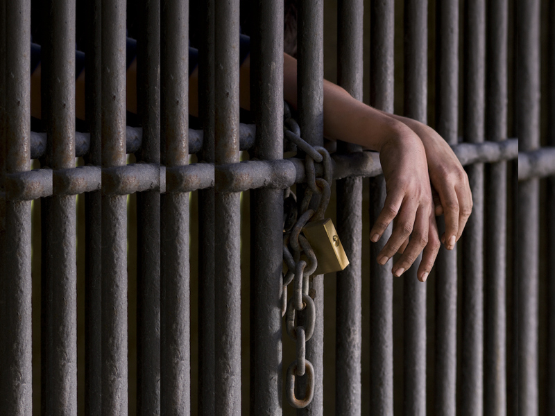 Hands behind bars