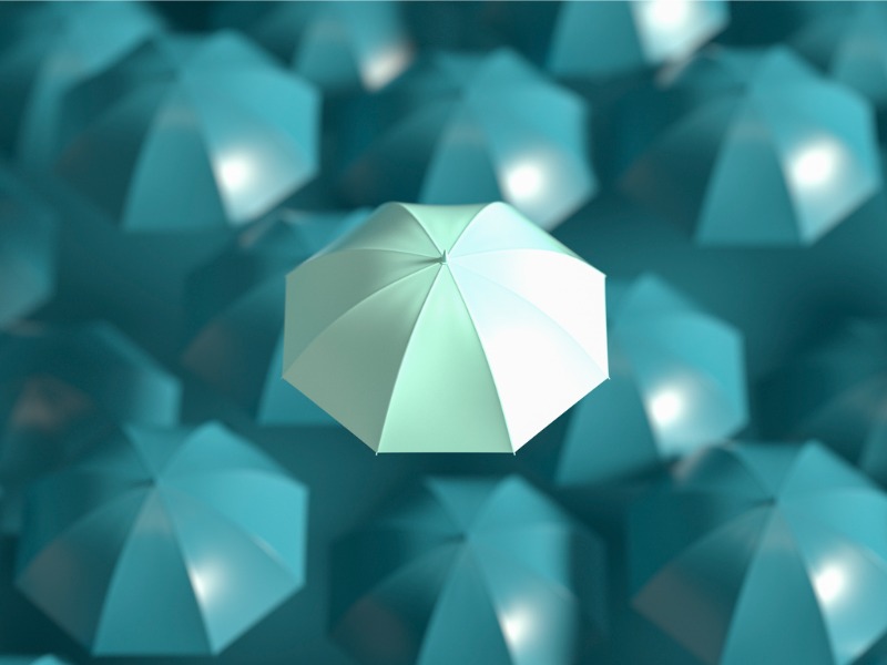 Umbrella standing out from the crowd