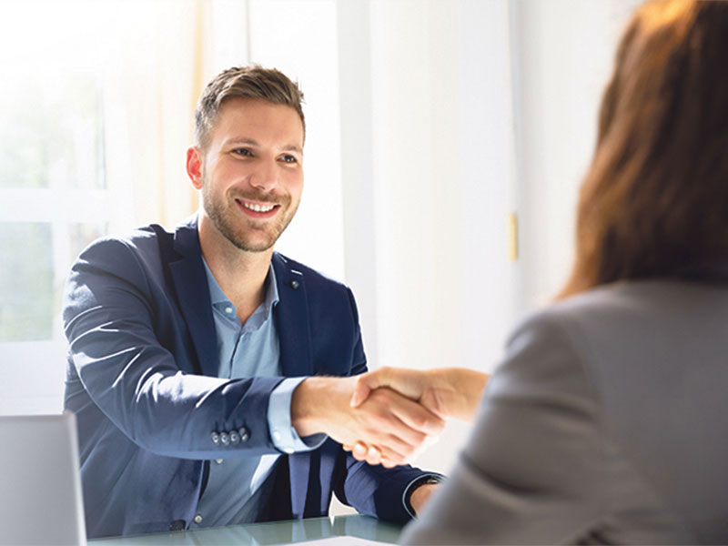 man shaking hands with a woman