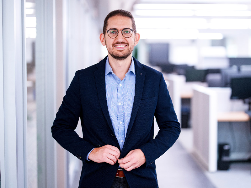 Businessman standing in an office hallway
