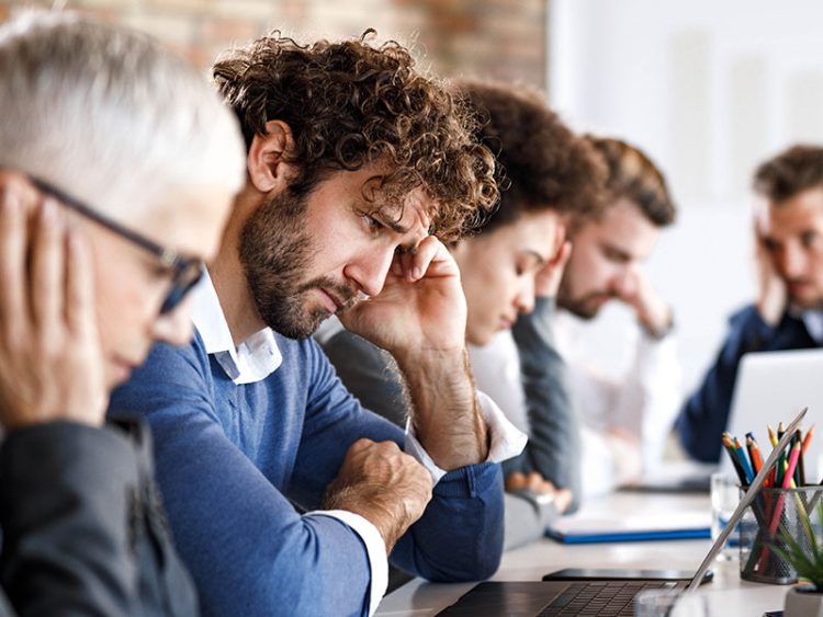 Man looking stressed in an office setting