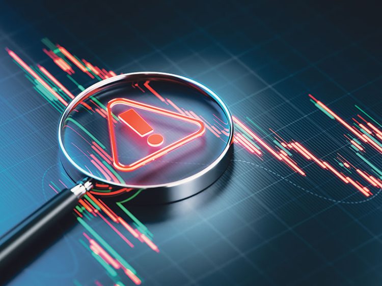 magnifying glass showing an error or warning on a stock market chart