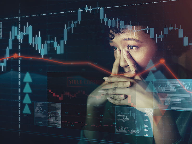 Anxious woman looking at a stock market screen