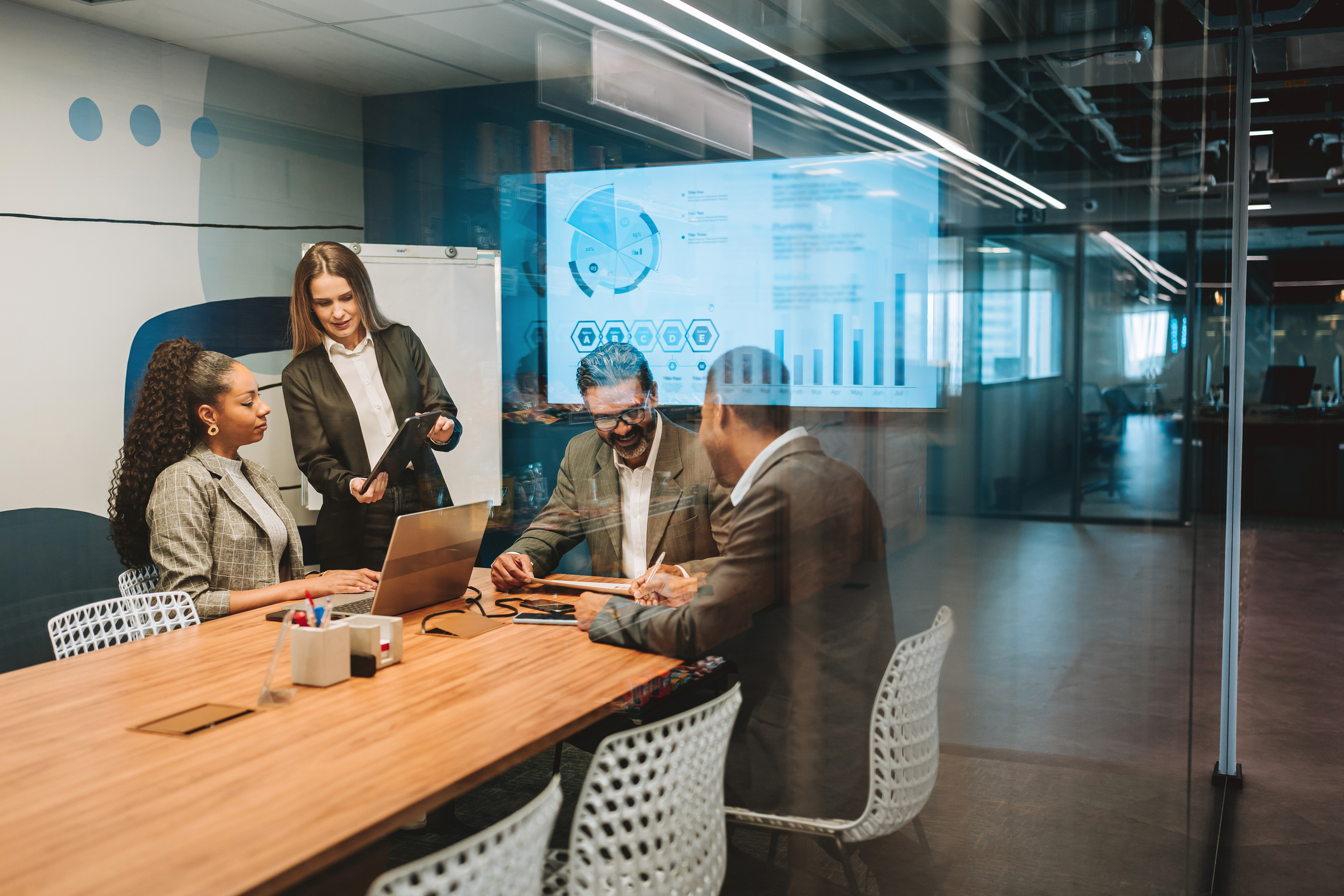 Business people talking in boardroom and using technology