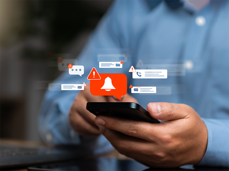 Image of a smartphone screen displays an audible warning about fraudulent calls, highlighting cyber threats from fraudulent callers and phishing attempts.