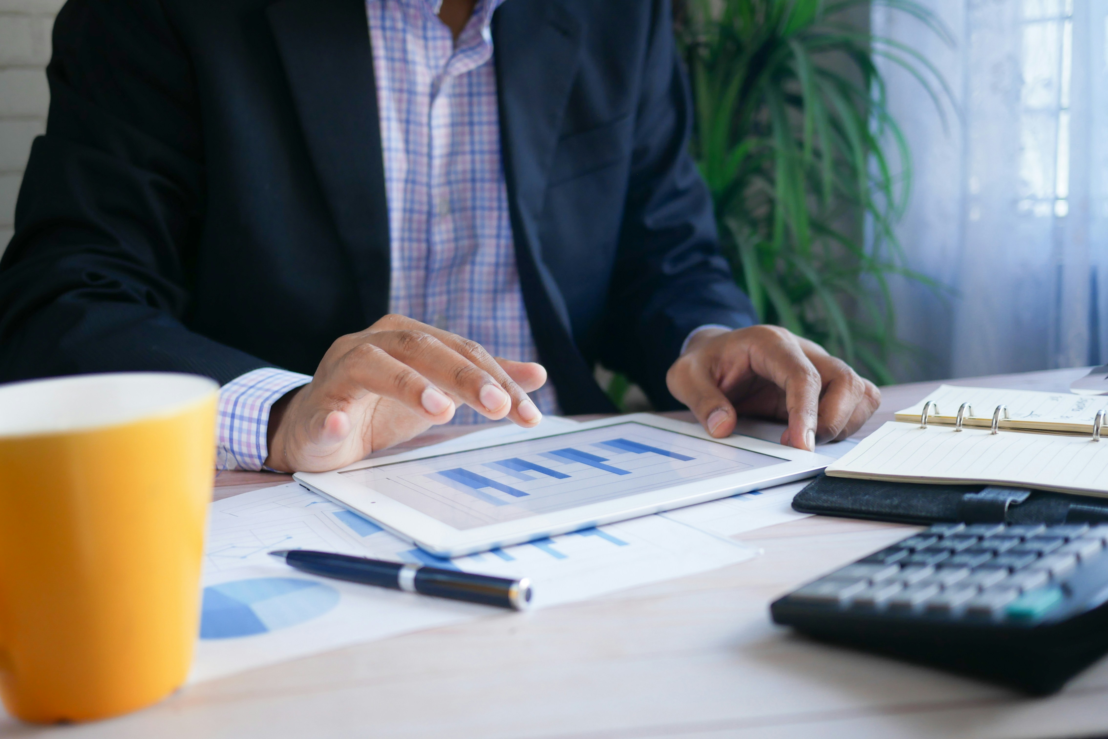 Portfolio manager reviewing fund analytics on a tablet